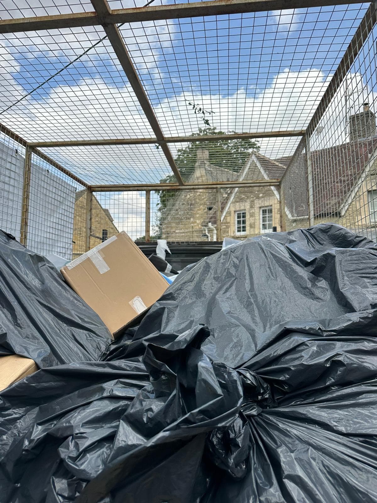 A ProWorks caged tipper loaded with bagged waste after a clearance